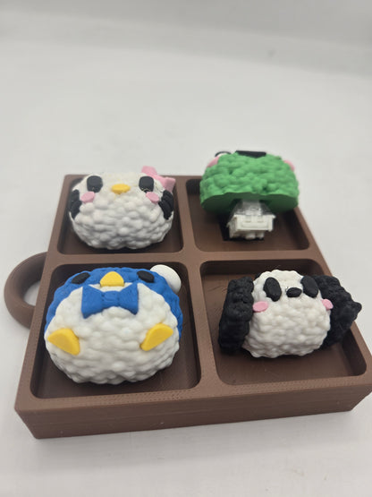 Sanrio themed rice ball tray fidget with the green frog piece lifted to show the mechanical key switch clicker underneath, 3D printed