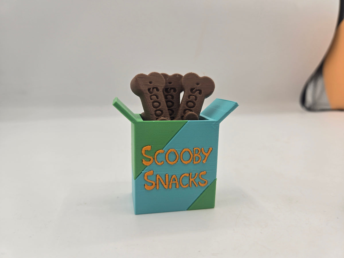 Scooby Snacks box key clicker 3D print, teal and green box with orange lettering and brown dog-bone treats on top