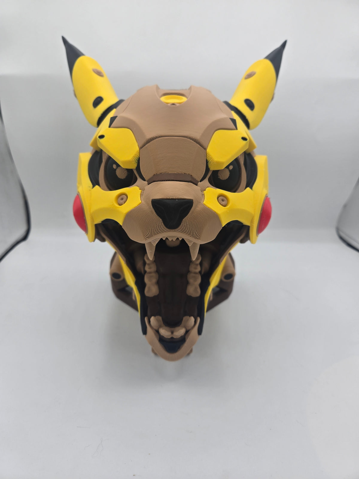 Mekachu Mecha Monster controller holder 3D print front view with jaw open showing teeth, yellow armor plates, black-tipped ears and red cheeks
