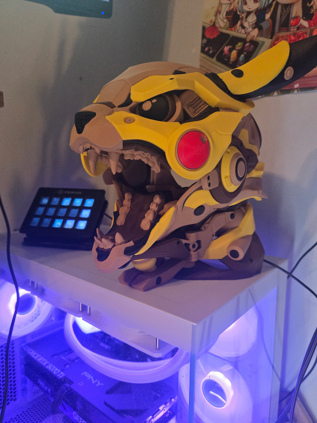 Mekachu Mecha Monster controller holder 3D print on a gaming PC desk beside a stream deck with purple LED lighting, angled side view