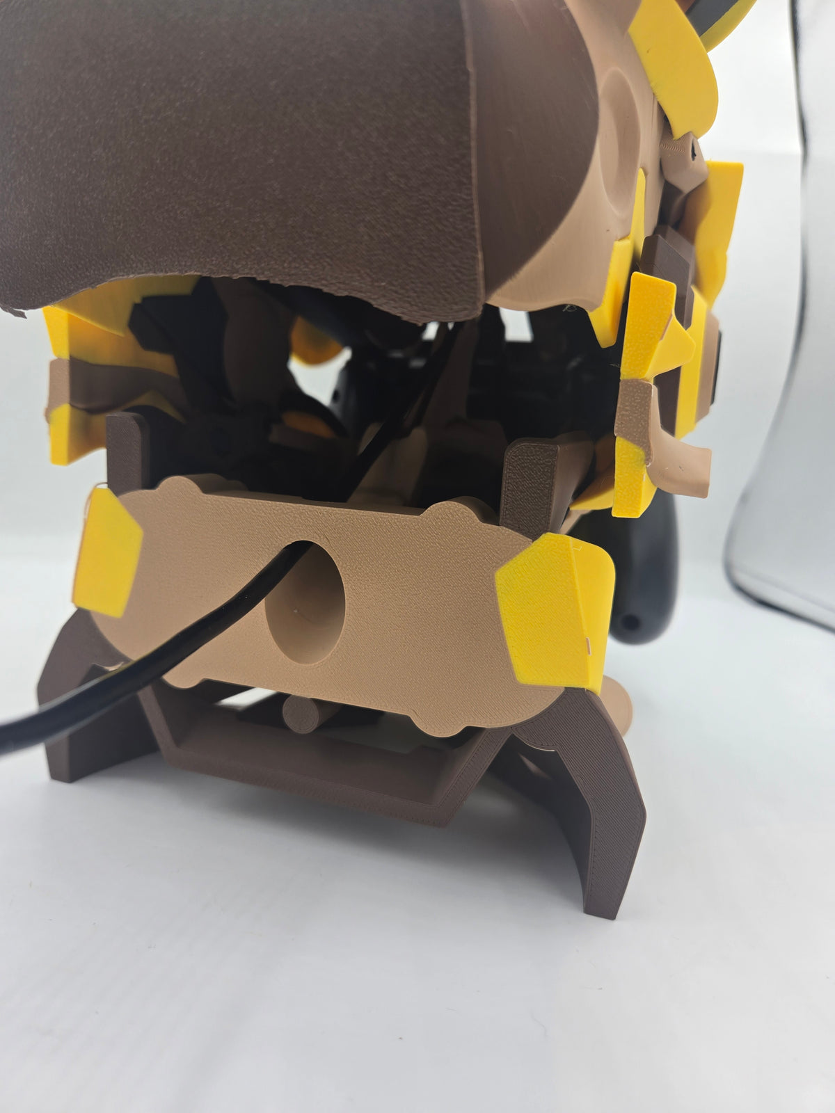 Mekachu Mecha Monster controller holder 3D print rear view showing the cord hole in the back panel with a charging cable routed through to the controller