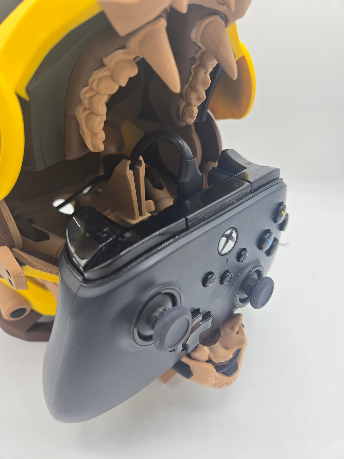 Mekachu Mecha Monster controller holder 3D print close-up of a controller resting in the open jaw with a charging cable plugged in