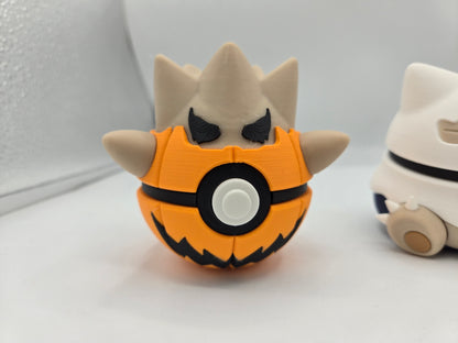 Pokémon Pokéball Inspired Clickers 3D print — Pumpkin Togepi style clicker, orange jack-o'-lantern shell with carved grin and tan spiky eggshell top with angry black eyes