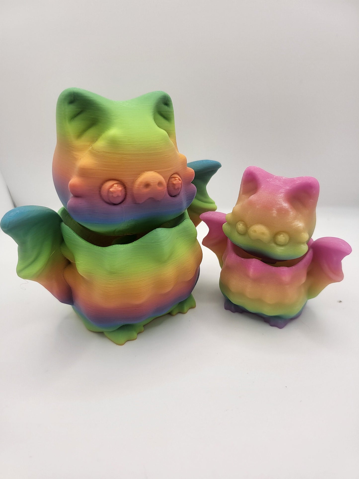 Bat bobble head figurine on desk — head wobbles on spring