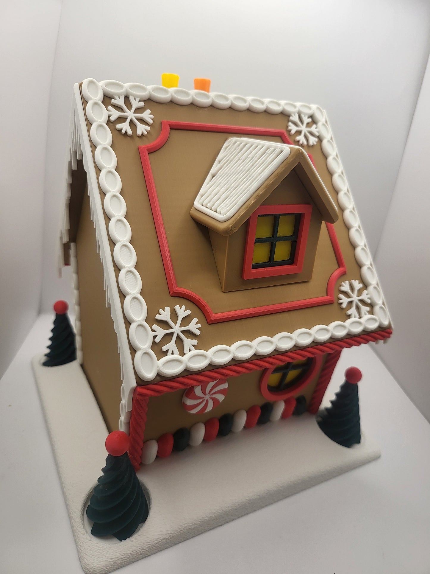 Holiday Gingerbread House Display seen from above — 3D printed roof with dormer window, snowflake details, and white icing bead trim