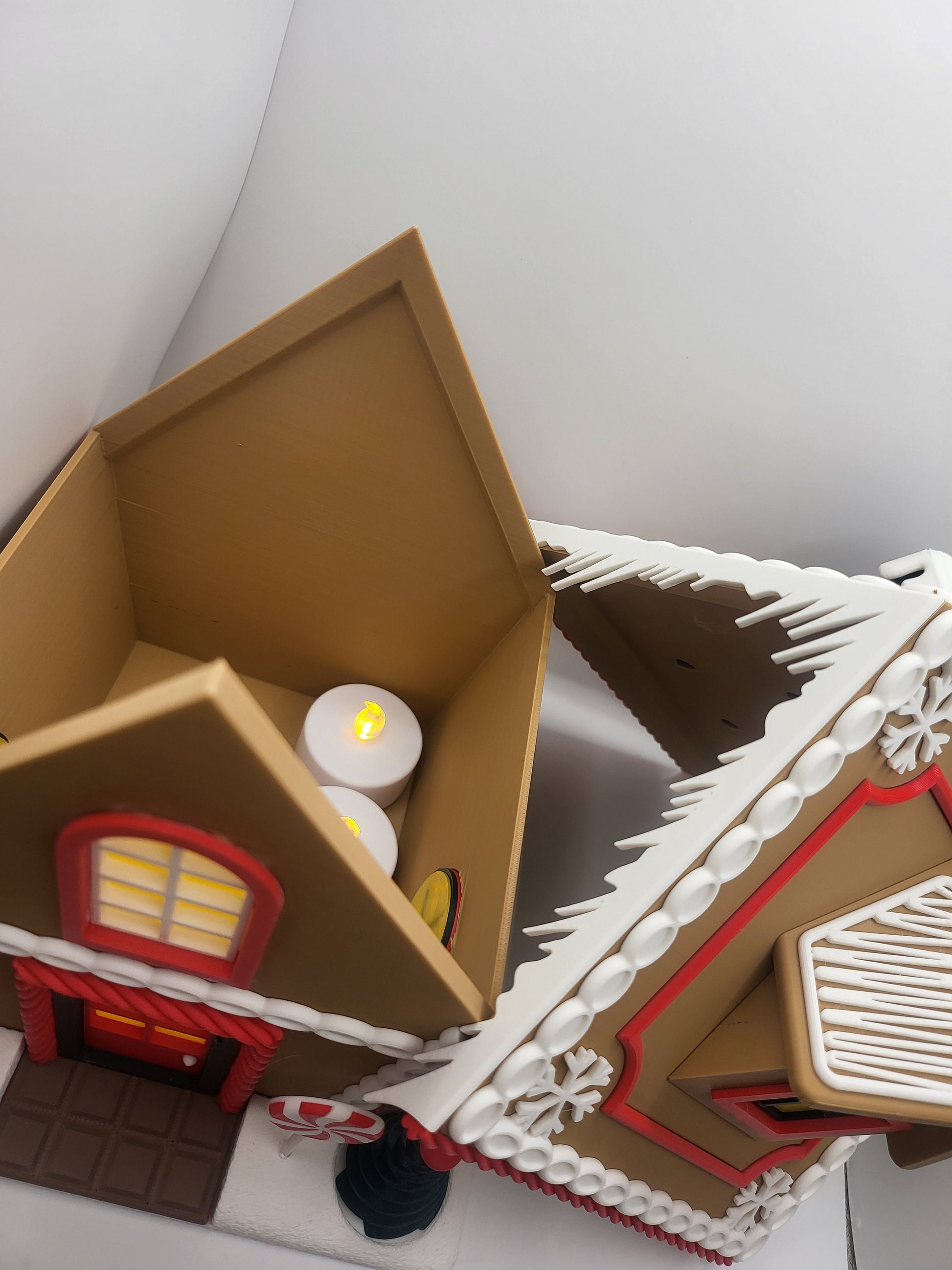 Holiday Gingerbread House Display with the roof lifted off — interior space holding LED tealight candles, 3D printed two-piece design
