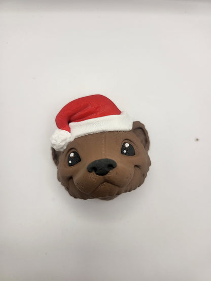 Ferret with Santa Hat ornament front view — smiling brown 3D printed ferret wearing a red Santa hat with white trim and pom