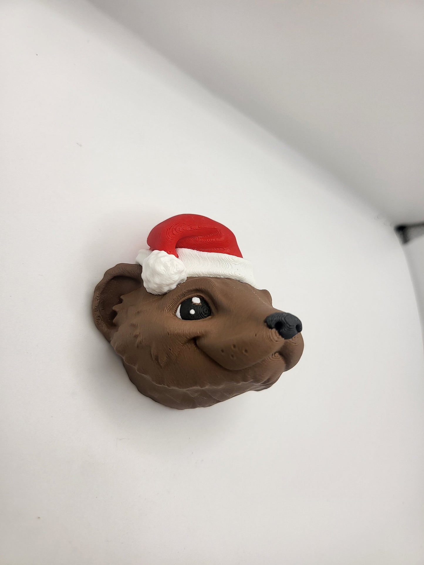 Ferret with Santa Hat ornament angled side view on a white background — brown filament with detailed fur texture, 3D printed