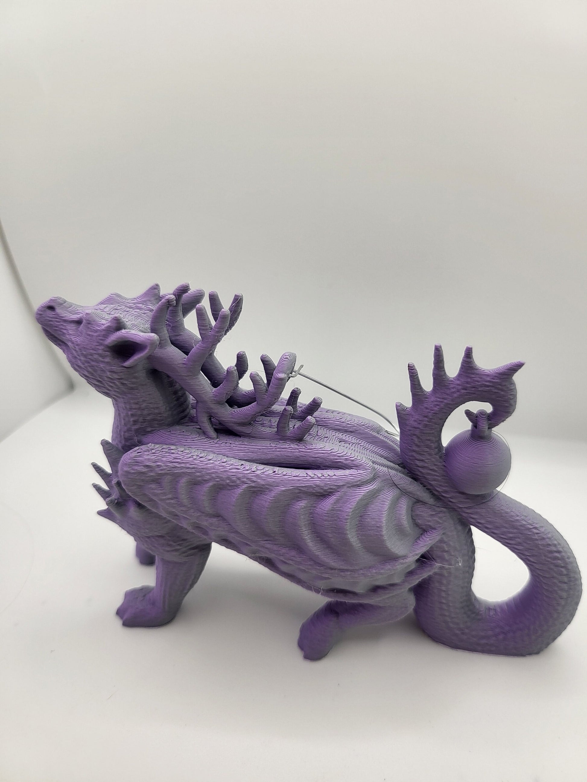 Dragon reindeer ornament set on Christmas tree branch