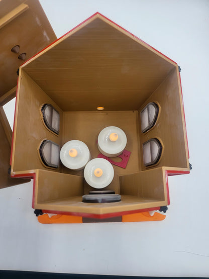 Halloween Gingerbread House with removable top lifted off — interior view showing three LED tealight candles glowing inside the 3D printed house