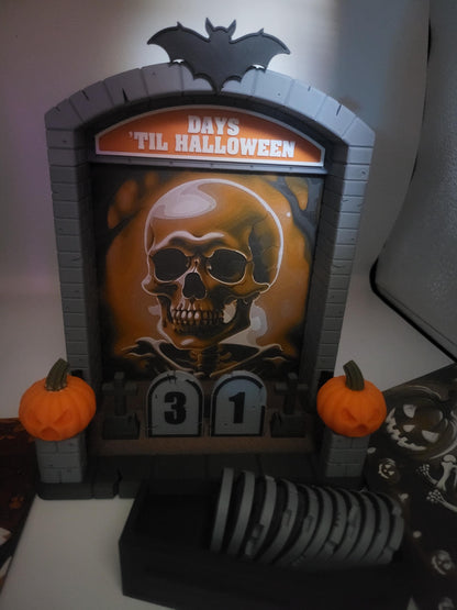 Halloween Countdown with detailed skull backdrop — orange Hueforge skull scene in the gray tombstone frame, 31 days shown, coffin of numbers below, 3D printed