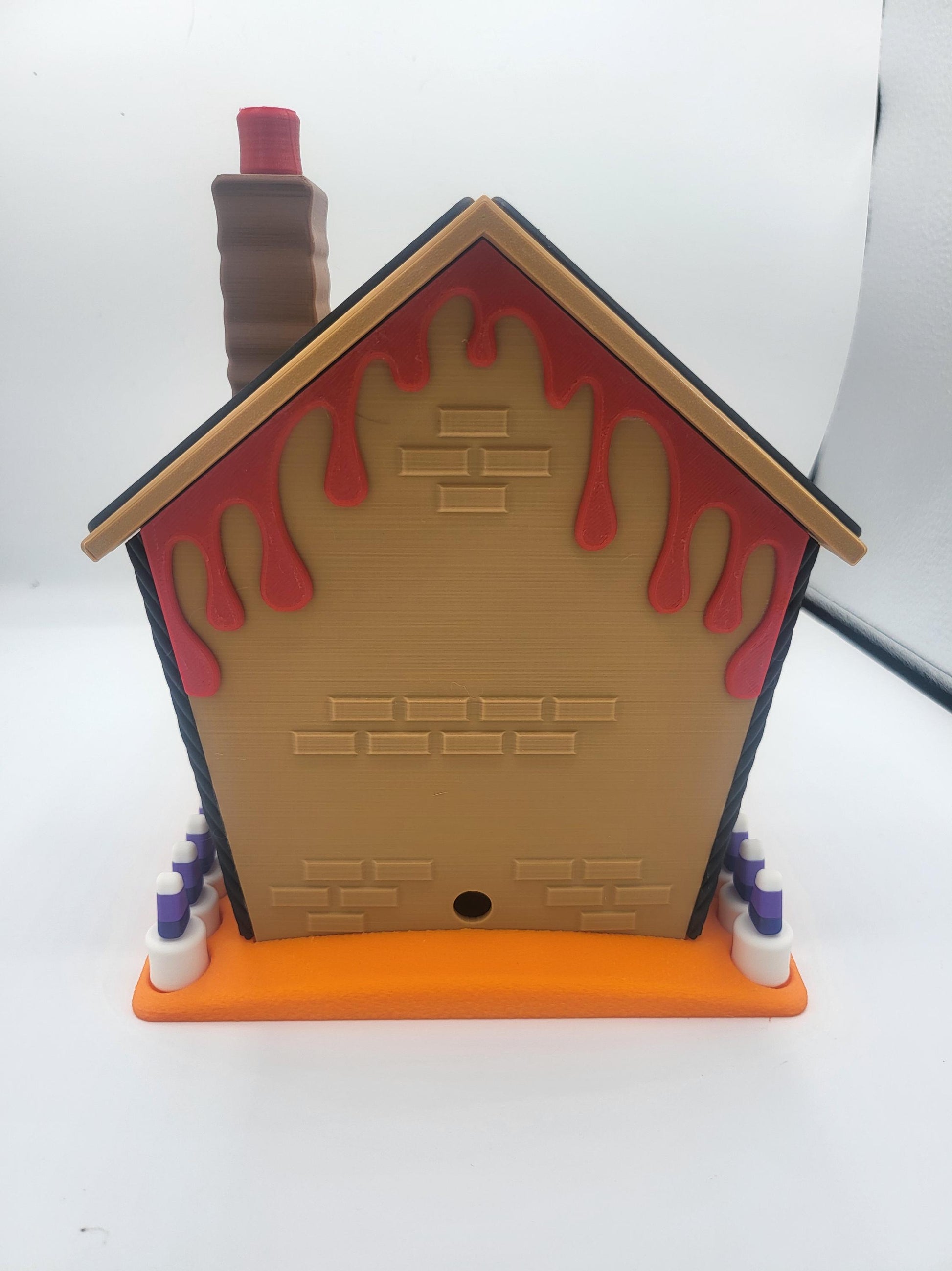 Halloween Gingerbread House back view — 3D printed rear wall with brick texture, red ooze dripping from the roofline, and tall chimney