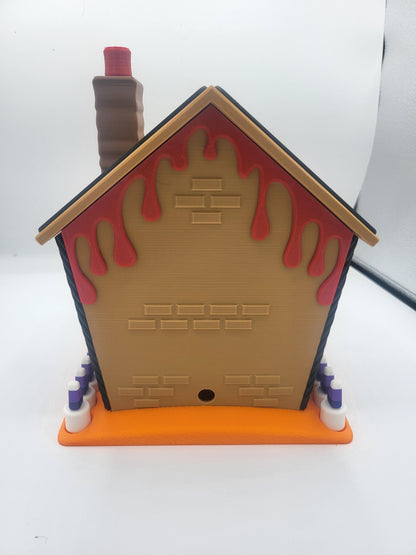 Halloween Gingerbread House back view — 3D printed rear wall with brick texture, red ooze dripping from the roofline, and tall chimney