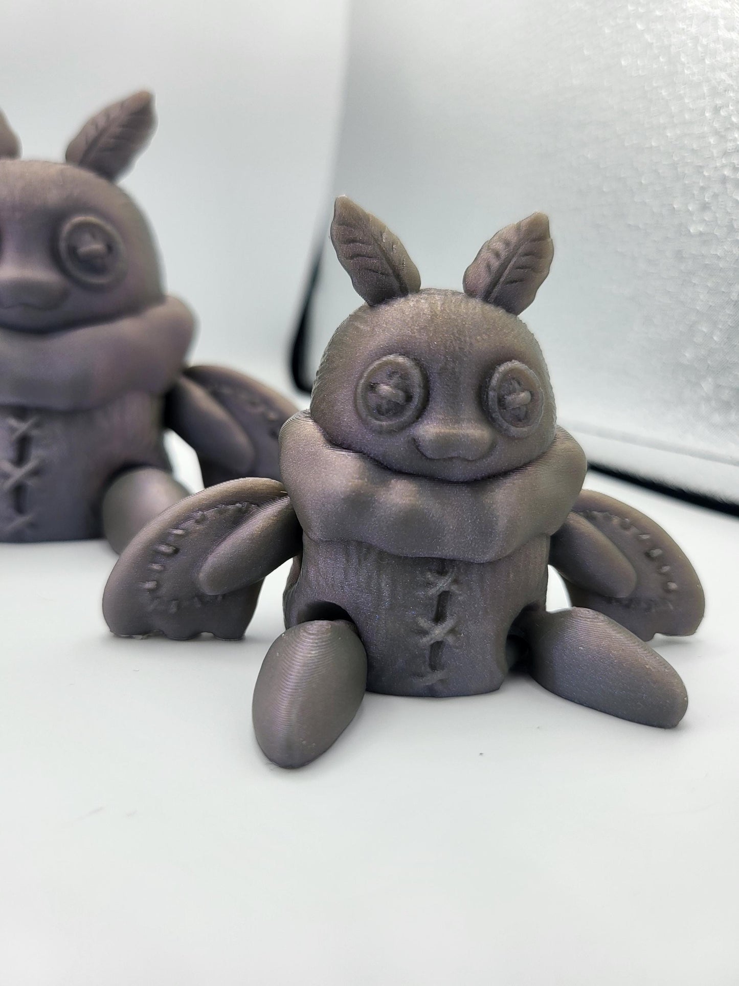 Close-up of plushie Mothman face — cute cryptid figurine