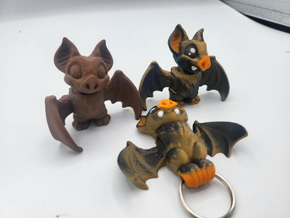 Palm-sized bat figurine side view showing articulated wings
