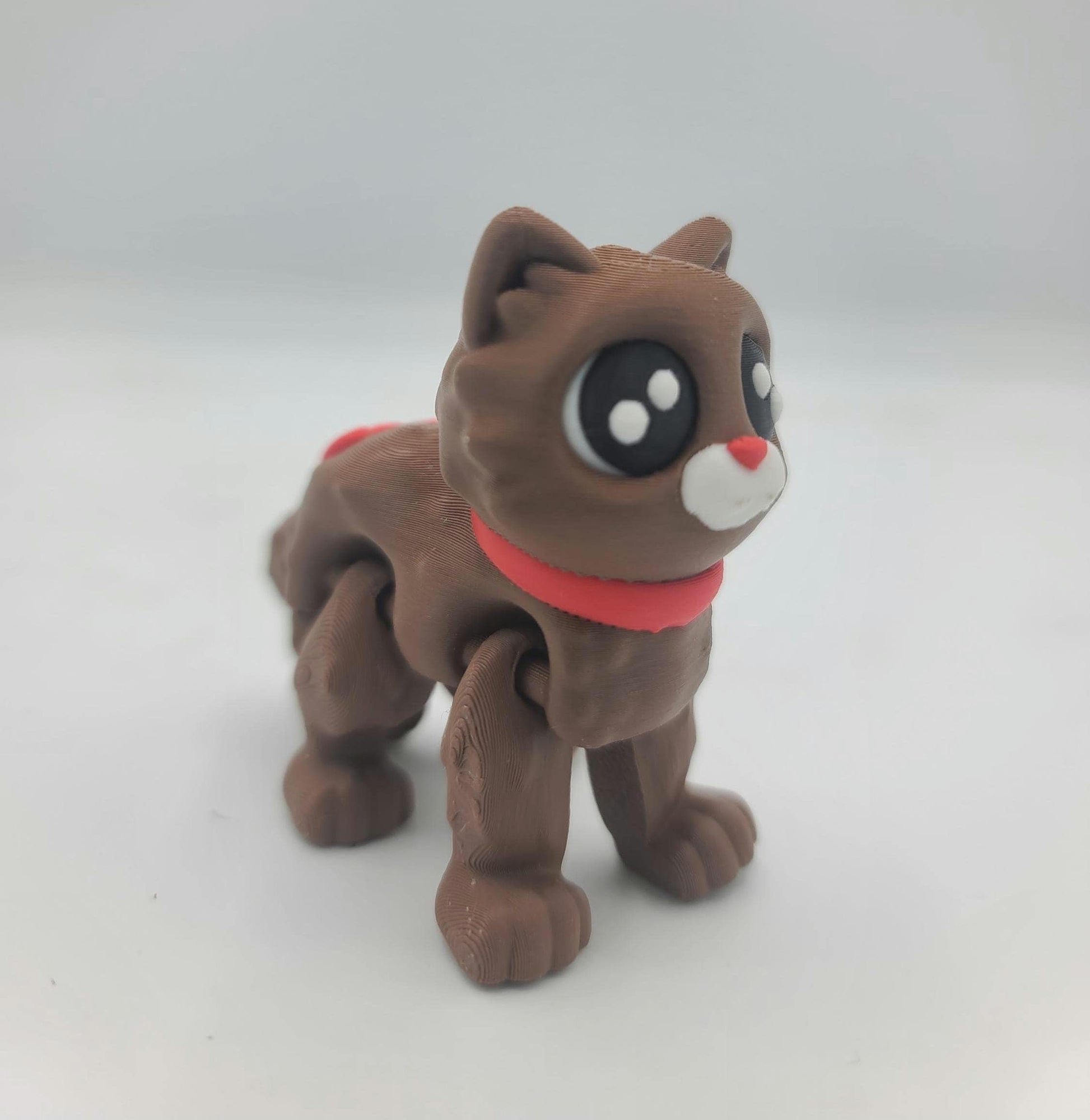 Cocoa Kitty in the No Hat style standing alone — chocolate-brown 3D printed flexi cat with red scarf and big dark eyes