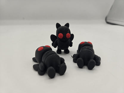 Mini Mothman figurine held in hand showing pocket-sized scale