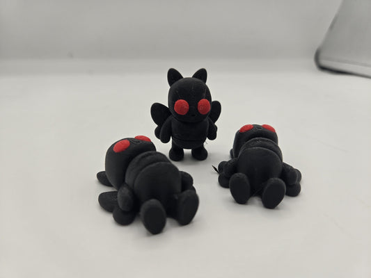 Mini Mothman figurine held in hand showing pocket-sized scale