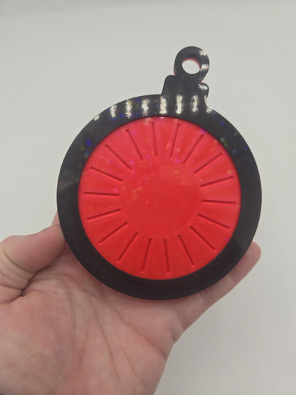 Back of the Christmas 25 Day Countdown ornament in hand, showing the red rotating dial used to change the day number — 3D printed with sparkle accents