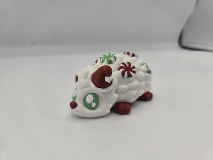 Peppermint Candies Christmas Hedgehog flexi, 3D printed — white hedgehog with Santa hat, green eyes, and red and green peppermint candies along its back