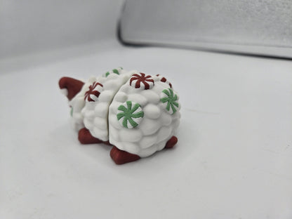 Peppermint Candies Christmas Hedgehog flexi, rear view — Santa hat peeking over mint-studded quills and red feet, 3D printed