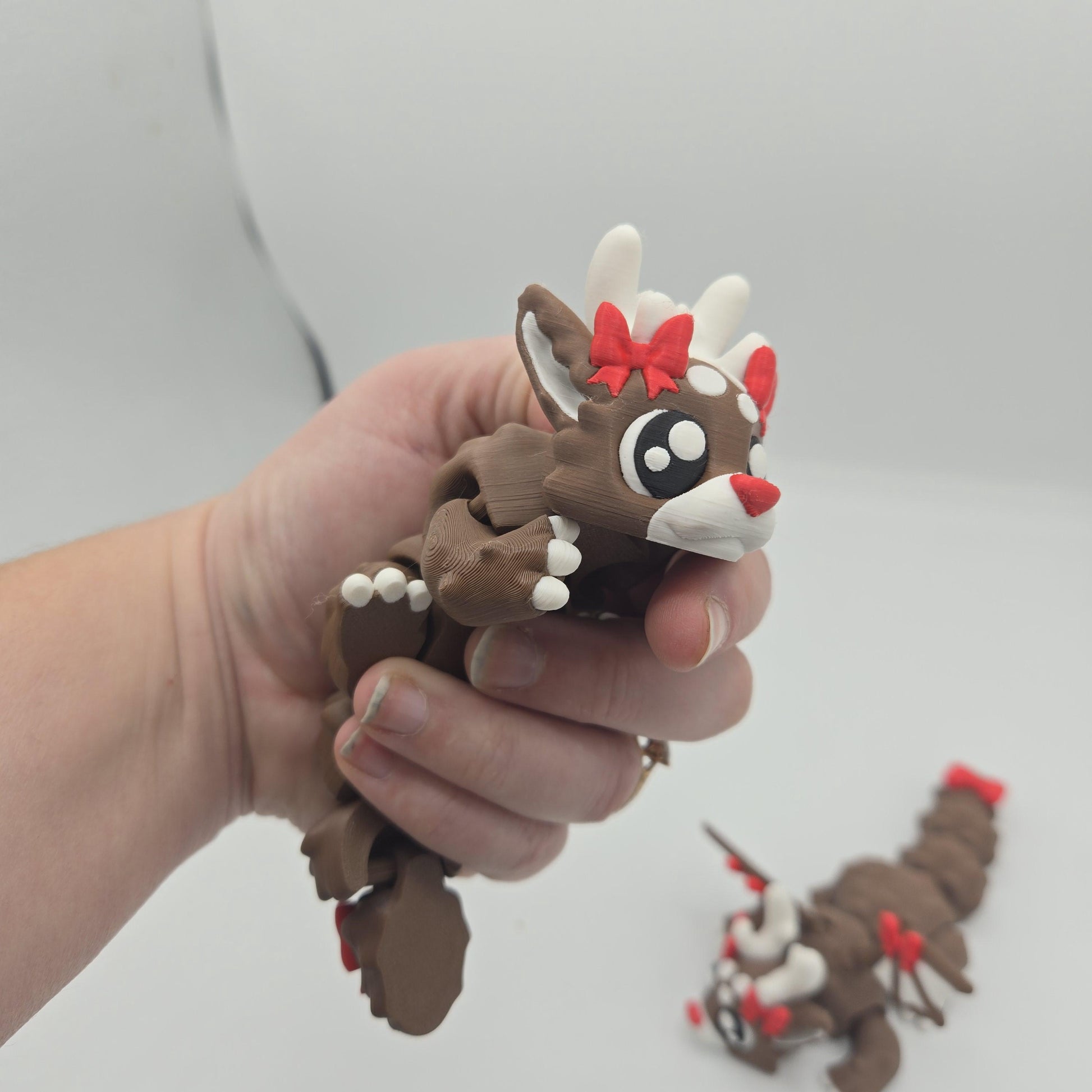 Dragon reindeer side view showing poseable dragon body and antlers