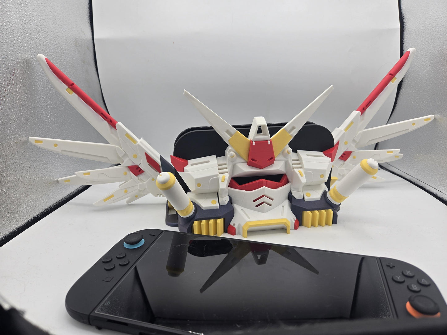 Mechdam Nintendo Switch 2 Dock Display with wings raised — 3D printed retro mecha dock shown with the Switch 2 console in front