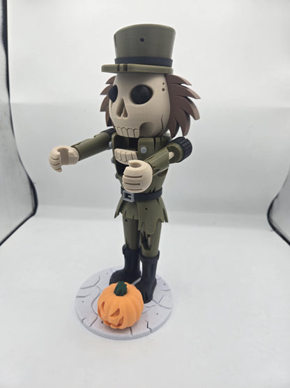 Side angle of the skull-faced nutcracker decoration with a jack-o'-lantern at its feet