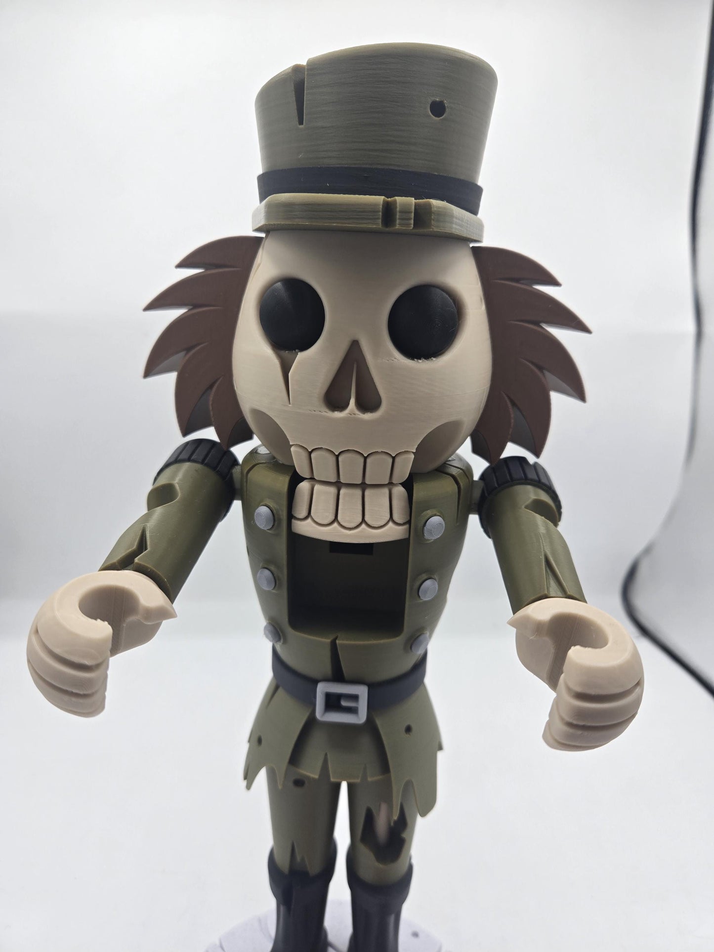 Close-up of the spooky nutcracker's skull face and open movable jaw showing teeth, with claw-like hands