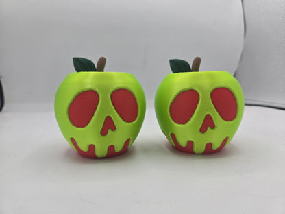 Pair of green poison apple tealight holders with red dripping skull faces and stem and leaf accents, lights off