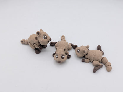 Mini quokka flexi trio in two-tone tan filament shown in sitting and lying poses