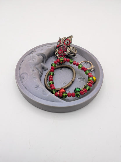 Side angle of the celestial moon trinket tray with jewelry inside, showing tray depth and raised edge