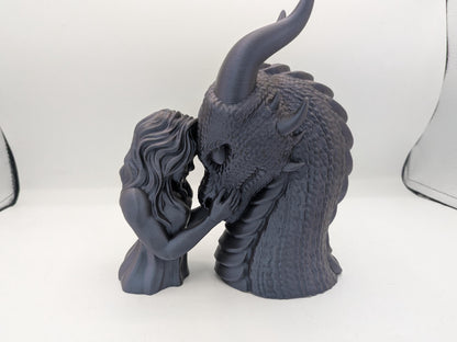 Dragon rider bonding statue 3D printed in dark silk filament — female rider resting her forehead against the dragon's snout, side view