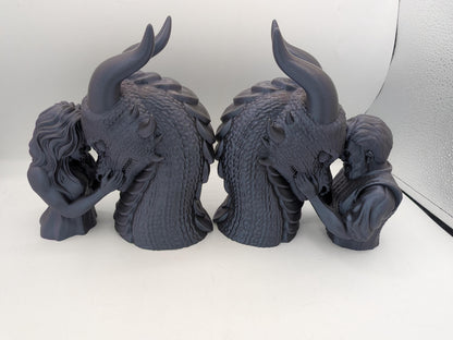 Two dragon rider bonding statues shown as a bookend pair, female rider and male rider versions back to back