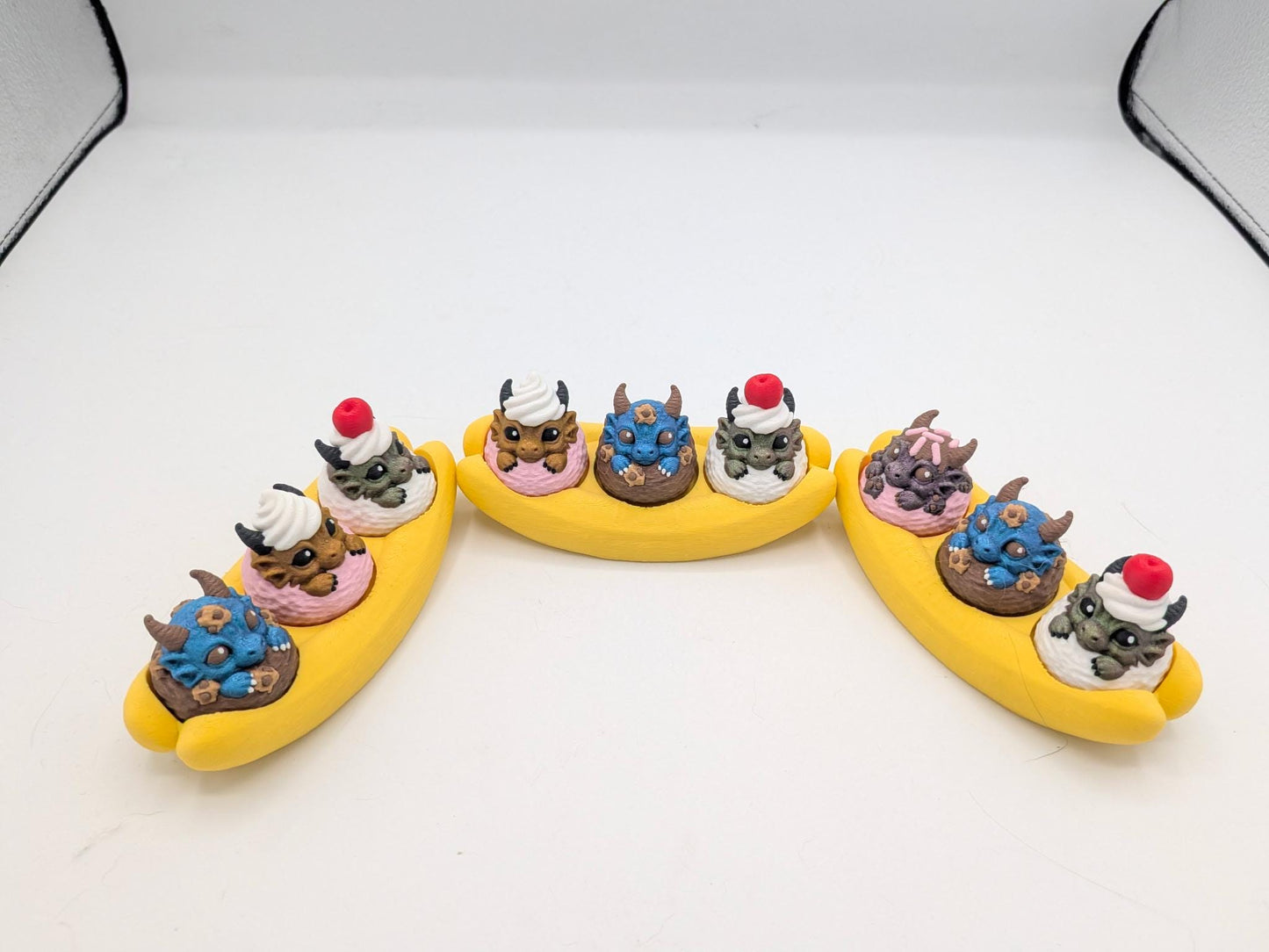 Three dragon banana splits with pressable mechanical key clicker scoops in varied colors