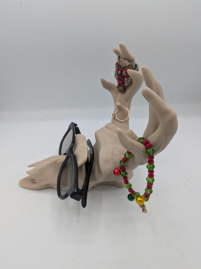 Deer skull stand in use — glasses resting in the slot with jewelry hanging from the antler tips