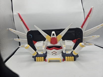 Mechdam Nintendo Switch 2 Dock Display, front view — console docked with wing blades spread wide and booster arms at the sides, 3D printed