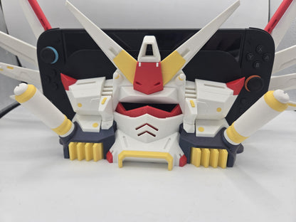 Mechdam Nintendo Switch 2 Dock Display close-up — mecha face and chest vents with the docked console's Joy-Con controllers visible behind, 3D printed