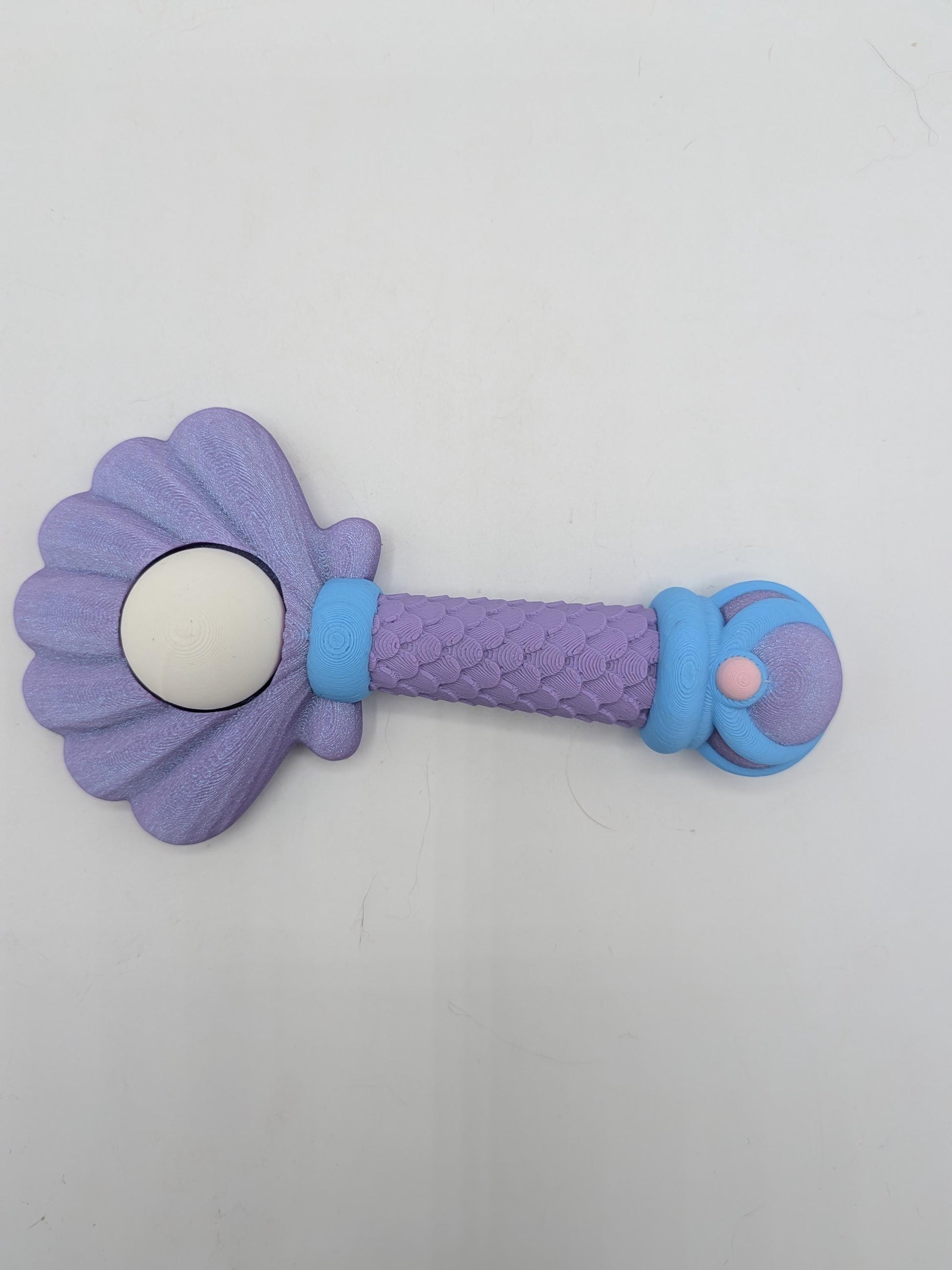Purple mermaid wand key clicker fidget with scalloped shell top, white pearl, and scaled handle