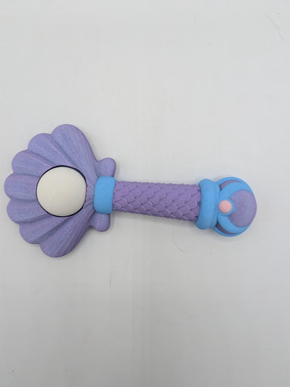 Purple mermaid wand key clicker fidget with scalloped shell top, white pearl, and scaled handle