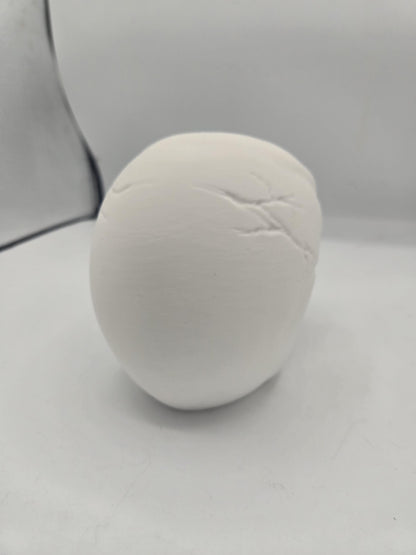 Back view of white human skull glasses holder showing rounded cranium with sculpted suture lines
