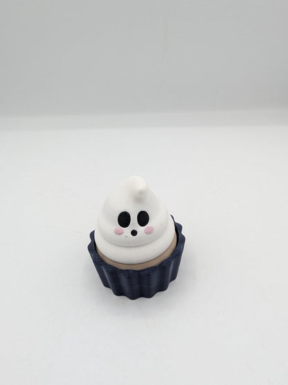 Ghost Halloween cupcake clicker fidget with white ghost frosting swirl face in a dark navy tin