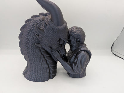 Close view of the male rider dragon bonding statue showing textured dragon scales and sculpted hair detail