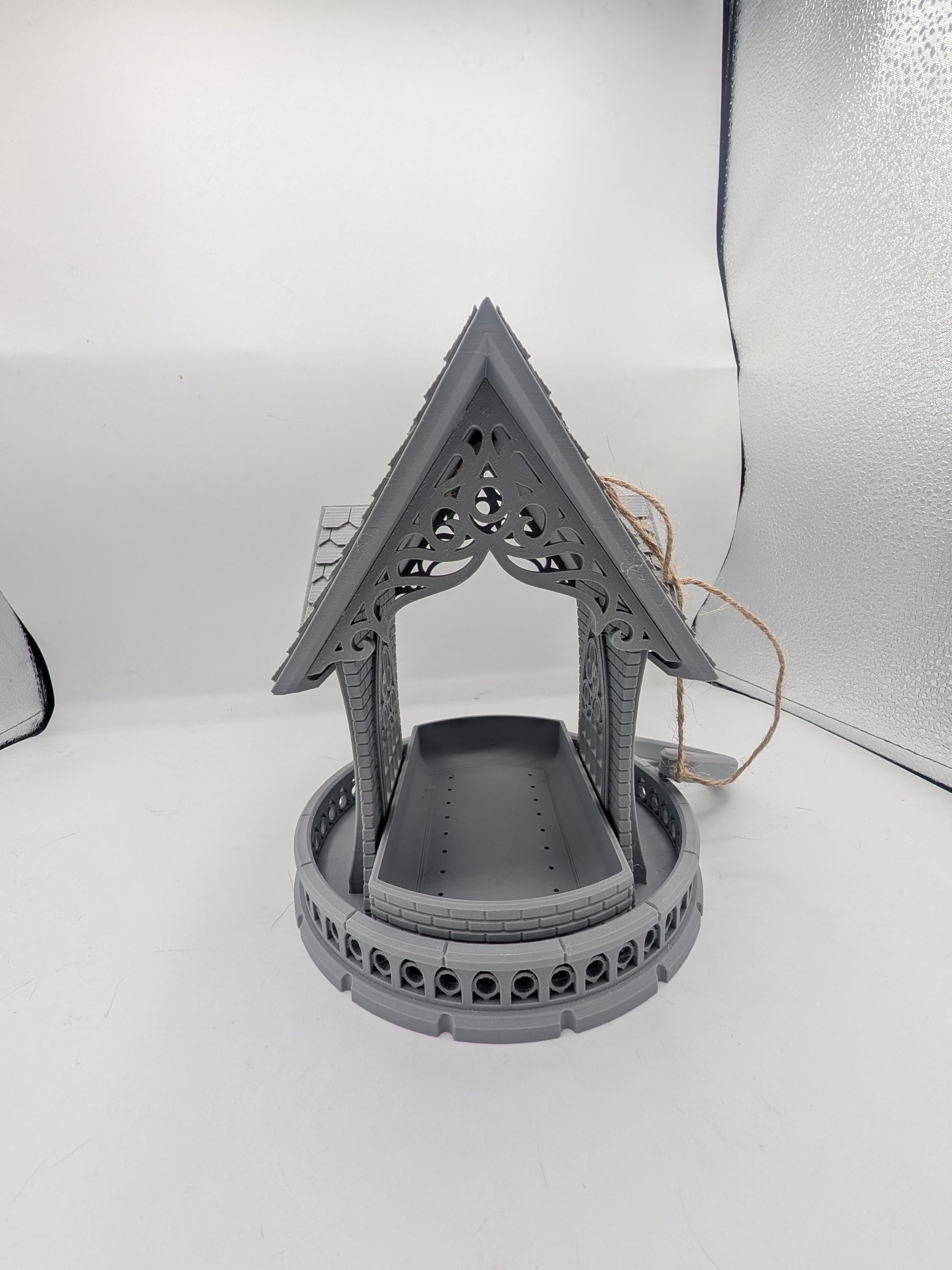 Front view of the gothic church bird feeder with seed tray under the carved tracery gable