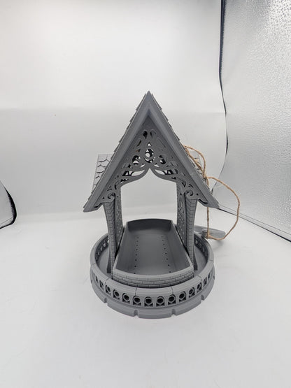 Front view of the gothic church bird feeder with seed tray under the carved tracery gable
