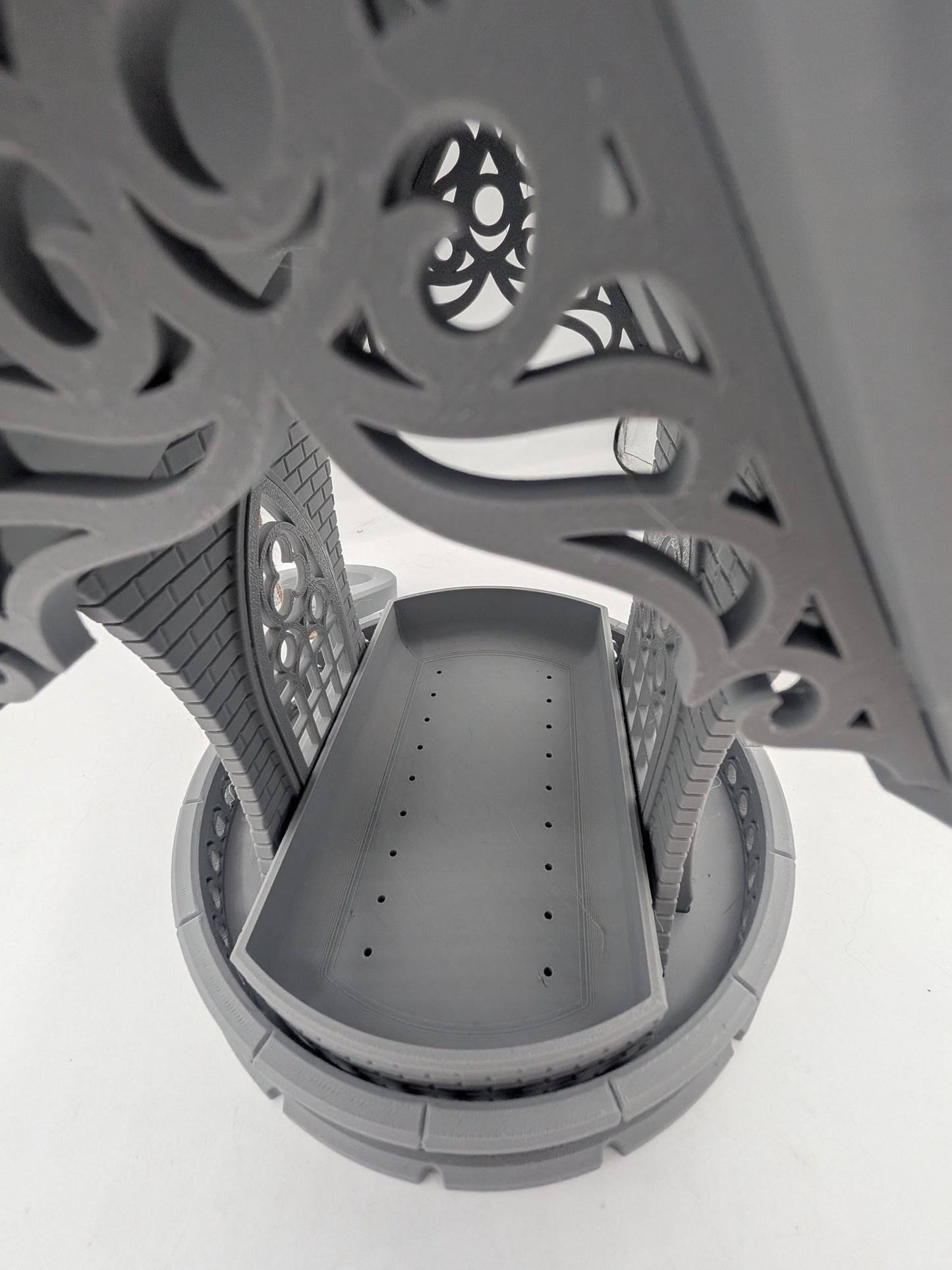 Looking down into the gothic church bird feeder seed tray, drainage holes visible