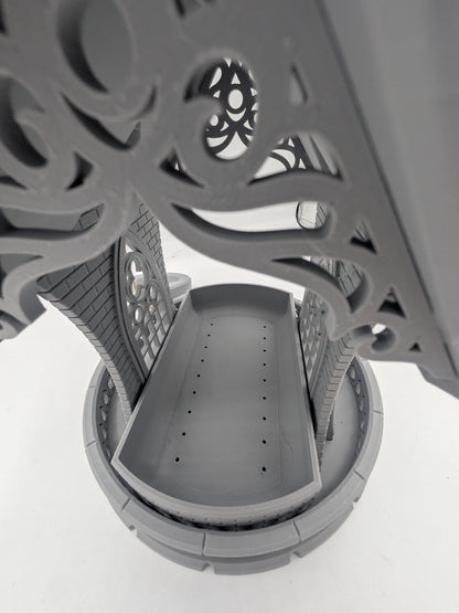 Looking down into the gothic church bird feeder seed tray, drainage holes visible
