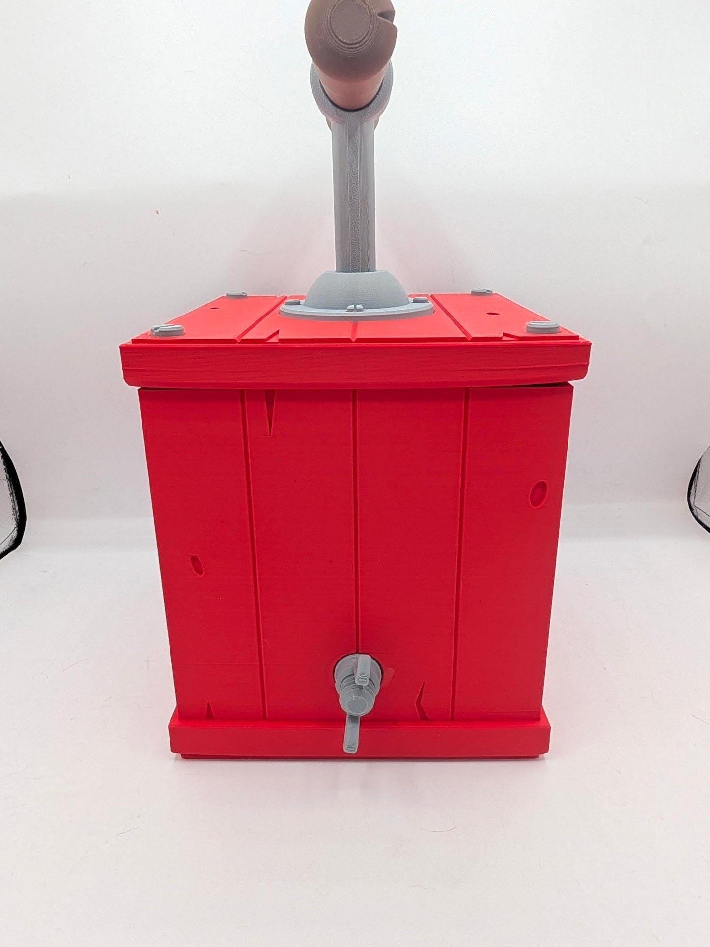 Back view of red TNT detonator birdhouse showing plank detailing and rear fastener, 3D printed