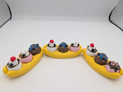 Back view of three dragon banana splits showing whipped cream swirls, cherries, and topping details