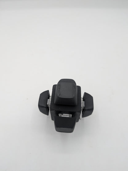 Top-down view of black clicker cube fidget with keycaps on all sides, 3D printed